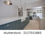 Small photo of Sible Hedingham, Essex - May 10 2017: Kitchen area in period style within refitted and restored 16th century home with range of units including peninsular marble top island