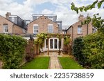 Small photo of Cambridge, England - Nov 1 2018: Traditional Cambridge housing showing variable roofline from multiple extensions including dormer roof and garden