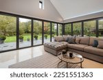 Small photo of Willingham, Cambridgeshire - October 30 2018: Luxury modern open living room with bifold patio doors and vaulted ceiling.