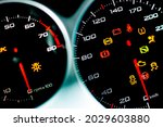 Car dashboard. Checking the system when starting the engine. A close-up of the speedometer and tachometer with additional instruments is illuminated. 