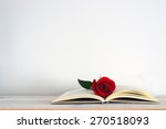 An Open Book With A Red Rose...