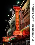 Small photo of New York, NY - USA - Sept 3, 2022 Vertical night-time view of the historic Nathan's flagship restaurant and it's iconic neon signage, in Coney Island, Brooklyn.