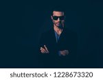 Small photo of Portrait of he nice adult lovely well-groomed self-content arrogant handsome attractive classy man in blazer suit eyewear isolated over dark black background
