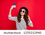 Portrait of nice lovely attractive wavy-haired lady wearing striped pullover sunhat taking making romantic selfie isolated over bright vivid shine red background