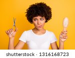 Close up photo beautiful amazing she her dark skin lady hold hair brush scissors hands pros cons ready change herself style wear casual white t-shirt isolated yellow bright vibrant vivid background