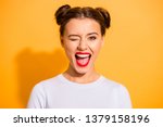 Close up portrait of lovely cute funny lady making winks opening her mouth shouting yeah having holidays dressed in white comfortable clothing isolated on bright background