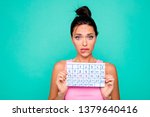Small photo of Close up photo beautiful amazing she her lady funny hairdo bite lips mouth hold hand arm paper calendar inconvenient situation oops wear casual pink tank-top isolated teal turquoise background