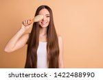 Portrait of her she nice-looking attractive lovely well-groomed cheerful cheery lady holding in hand comb closing face smooth soft silky hair effect keratin isolated on beige pastel background