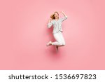 Full length body size photo of charming crazy ecstatic overjoyed woman wearing trousers pants jumping up isolated pastel color background