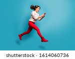 Full length body size view of nice attractive cheerful amazed impressed girl jumping using 5g like follow subscribe running hurry rush isolated on bright vivid shine vibrant blue color background