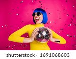 Photo of funny excited lady student party nightclub hold disco ball dancing queen confetti fall wear retro specs yellow turtleneck blue short wig isolated bright pink color background