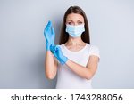 Small photo of Portrait closeup photo of citizen lady keep social distance crowd people contact hospital examination put on gloves hundred per cent protection wear face mask isolated grey color background