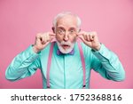 Closeup photo of excited crazy attractive grandpa open mouth listen good news astonished taking off specs wear mint shirt suspenders bow tie isolated pastel pink color background