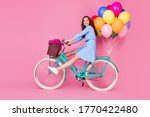 Full length body size profile side view of attractive cheerful cheery wavy-haired lady riding bike without legs delivering decoration event having fun isolated pink pastel color background