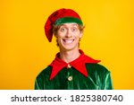 Close-up portrait of his he nice attractive cheerful cheery funny guy elf wearing festal clothes enjoying Eve Noel fairy isolated over bright vivid shine vibrant yellow color background