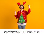 Photo of excited girl in christmas tree sweater pullover deer headband balls raise fists x-mas time noel lottery sale win isolated over bright shine color background