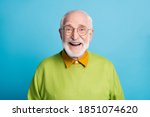 Photo of retired old man open mouth shiny smile excited wear glasses green pullover isolated blue color background