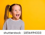 Portrait of happy excited amazed open mouth kid child girl look in copyspace isolated on yellow color background