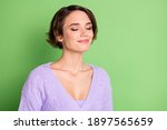 Portrait of adorable young girl closed eyes smile enjoying smell wear purple clothing isolated on green color background