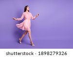 Full body profile photo of cheerful person walking wear retro stilettos isolated on purple color background