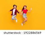 Full size portrait of two excited persons enjoy jumping open mouth isolated on yellow color background