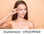 Small photo of Portrait of attractive dreamy girl showing place near eye temple botox prick isolated over beige pastel color background