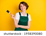 Photo of happy smiling good mood woman construction worker laughing hold paint brush isolated on yellow color background