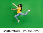 Full length body size side profile photo dreamy girl brunette jumping running catching isolated vibrant green color background