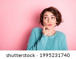 Portrait of nice unsure curly brunette hairdo lady finger face look empty space wear blue sweater isolated on pastel pink color background
