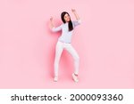 Full length body size view of attractive dreamy cheerful girl dancing having fun rest pastime isolated over pink pastel color background