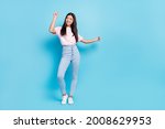 Full length body size view of attractive cheerful slender carefree girl dancing moving isolated over bright blue color background