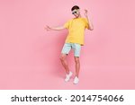 Full body photo of cheerful young happy man dance wear sunglass vacation summer isolated on pink color background