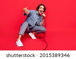 Full size photo of young woman happy positive smile singer rapper celebrity isolated over red color background