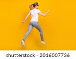 Back rear spine view photo of young woman jump up run empty space dream sale isolated on yellow color background
