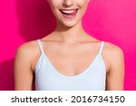 Cropped view portrait of attractive cheerful girl licking lip isolated over bright pink magenta fuchsia color background