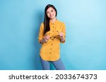 Photo of young attractive asian business woman happy positive smile hold eyeglasses isolated over blue color background
