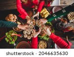 Top view of family celebrating winter holidays together drinking champagne at festive table