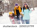 Photo of excited family happy positive smile mommy daddy daughter have fun playful snowy walk park free time