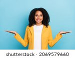 Photo of young black woman happy positive smile hold hands product promo ads isolated over blue color background
