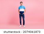 Small photo of Full length photo of cool brunet young guy stand wear polo jeans sneakers isolated on pink background