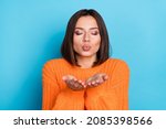 Small photo of Portrait of attractive dreamy affectionate amorous girl sending you air kiss date isolated over bright blue color background