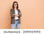 Small photo of Photo of self-assured business lady folded hands wear eyewear khaki shirt jeans isolated beige color background