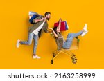 Small photo of Full size profile side photo of young girl guy fast rush shopping center discount isolated over yellow color background