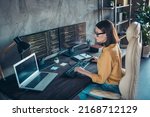 Small photo of Profile side view portrait of attractive focused skilled girl web developer using laptop at workplace workstation indoors