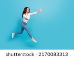 Photo of excited adorable woman wear white shirt jumping high open arms empty space isolated blue color background