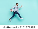 Small photo of Full size portrait of active energetic person hurry rush fast empty space isolated on turquoise color background