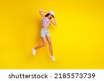 Full length photo of cute dreamy girl dressed swimsuit bra cap jumping up empty space isolated yellow color background