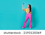 Full length photo of pretty cute girl dressed cropped top recording self video modern gadget empty space isolated teal color background