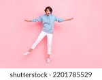 Small photo of Full body photo of astonished terrified lady stylish clothes stand one foot look empty space high scary isolated on pink color background
