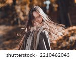 Profile photo of cute brown hairdo millennial lady walk in park wear coat scarf at the street in fall